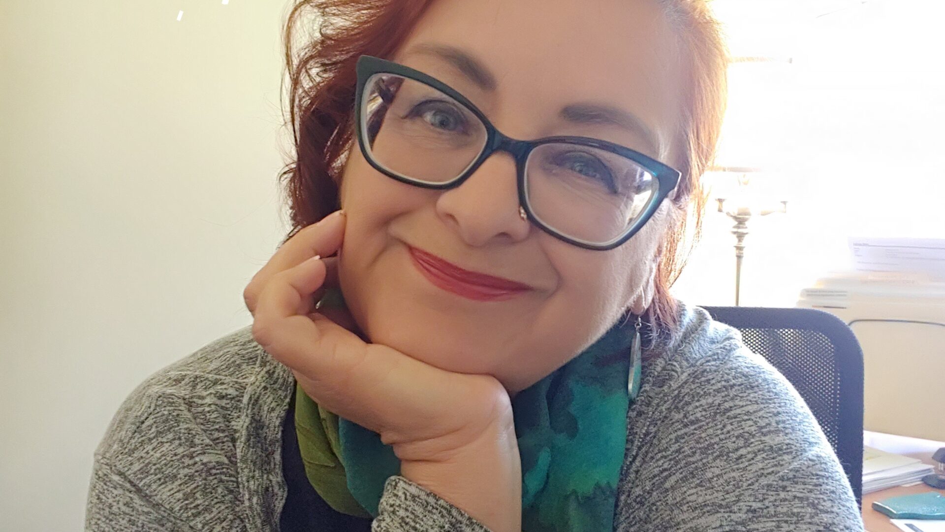 Headshot of Patricia Q Bidar, in glasses and green sweater.